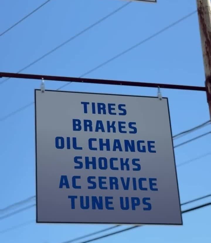Exeter Auto Clinic service sign: tires, brakes, oil change, shocks, AC service, tune ups.